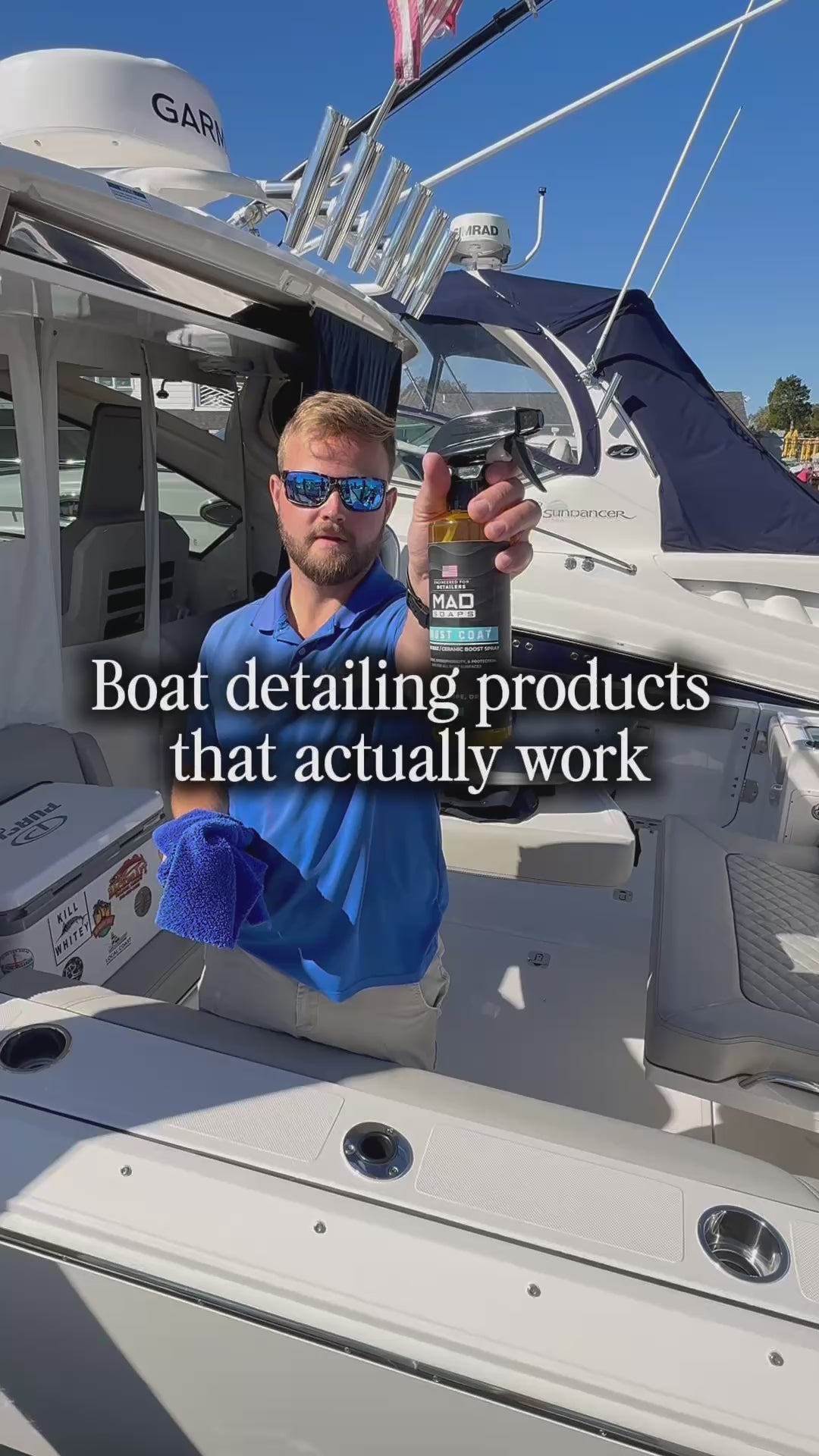 Chris from MAD Soaps spraying Boost Coat carnauba spray sealant onto a boat and wiping it with a Sandman microfiber towel to show the shine and water-beading protection.